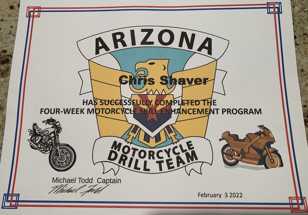 A certificate with the emblem of the Arizona Motorcycle Drill Team and two motorcycles on it, along with the signature of the captain of the drill team