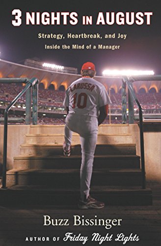 A book cover with the title and author's name, featuring a picture of the back of a man in a baseball uniform straddling steps leading to the field, with a portion of the stadium stands and lights and night sky visible in the background