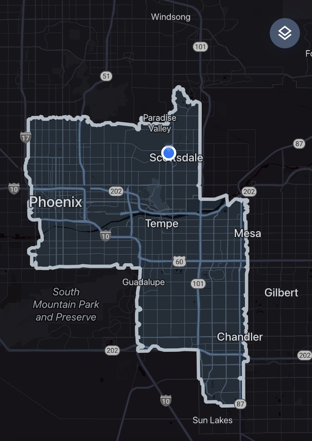 A dark map of the Phoenix metropolitan area with a black background and major streets shown in grey, in the center of which an area is highlighted in lighter shades, with labels for cities including Phoenix, Tempe, Scottsdale, Mesa, and Chandler