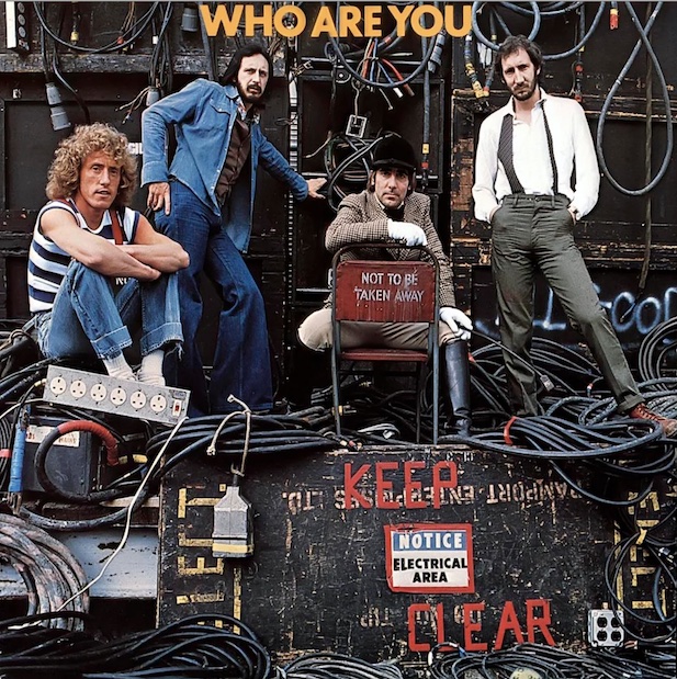 The cover for The Who's 1978 album entitled 'Who Are You', showing the four band members atop and before stacks of powerful audio equipment and electrical gear